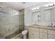 Well lit bathroom with walk in glass shower and double vanity with granite counter tops at 1675 Brewer Sw Blvd, Atlanta, GA 30310
