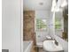 Cozy bathroom featuring a tiled shower and vanity with a bright mirror at 1675 Brewer Sw Blvd, Atlanta, GA 30310
