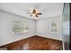 Bedroom featuring hardwood floors, ceiling fan, and two windows for natural light at 1675 Brewer Sw Blvd, Atlanta, GA 30310