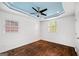 Bedroom with hard wood floors, ceiling fan and blue painted tray ceiling at 1675 Brewer Sw Blvd, Atlanta, GA 30310