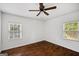 Bedroom with hardwood floors, a ceiling fan, and large windows at 1675 Brewer Sw Blvd, Atlanta, GA 30310