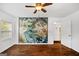 Large bedroom with hard wood floors and an ornate mural at 1675 Brewer Sw Blvd, Atlanta, GA 30310