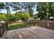 Spacious wooden deck surrounded by a well-maintained backyard and mature trees at 1675 Brewer Sw Blvd, Atlanta, GA 30310