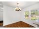 Charming dining area with hardwood floors and chandelier, complemented by natural lighting at 1675 Brewer Sw Blvd, Atlanta, GA 30310