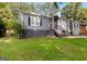Charming single-Gathering home featuring gray siding and a well-maintained front lawn and landscape at 1675 Brewer Sw Blvd, Atlanta, GA 30310
