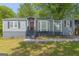 Charming single-story home featuring a red door, bay window, and gray siding at 1675 Brewer Sw Blvd, Atlanta, GA 30310