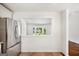 Bright kitchen with stainless steel refrigerator and view into living room at 1675 Brewer Sw Blvd, Atlanta, GA 30310