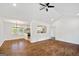 Spacious living room featuring hardwood floors, modern ceiling fan and an open layout to the kitchen at 1675 Brewer Sw Blvd, Atlanta, GA 30310