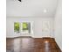Bright living room with bay windows, hardwood floors and white walls ready for your personal touch at 1675 Brewer Sw Blvd, Atlanta, GA 30310