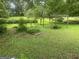 Landscaped backyard with garden, trellises, and mature trees provides a serene outdoor space at 212 Rockmart Rd, Villa Rica, GA 30180