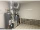 Utility basement featuring water heater and HVAC with stone foundation at 212 Rockmart Rd, Villa Rica, GA 30180