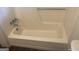 Clean white bathtub with chrome fixtures, perfect for a relaxing bath experience at 212 Rockmart Rd, Villa Rica, GA 30180