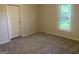 Bedroom with a large window and light neutral paint at 212 Rockmart Rd, Villa Rica, GA 30180