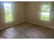 Corner bedroom with two windows offering serene outdoor views and natural light at 212 Rockmart Rd, Villa Rica, GA 30180
