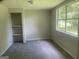 Cozy bedroom boasts natural light and closet space, creating a comfortable retreat at 212 Rockmart Rd, Villa Rica, GA 30180