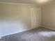 Bedroom featuring bi-fold closet doors and light neutral paint at 212 Rockmart Rd, Villa Rica, GA 30180