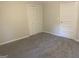 Bedroom featuring bi-fold closet doors and light neutral paint at 212 Rockmart Rd, Villa Rica, GA 30180