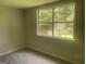Bedroom with a large window and light neutral paint at 212 Rockmart Rd, Villa Rica, GA 30180