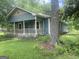 Charming home featuring a cozy front porch, stone accents, and lush green lawn at 212 Rockmart Rd, Villa Rica, GA 30180