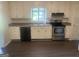 Bright kitchen with stainless steel appliances, ample cabinets, and a view of the backyard at 212 Rockmart Rd, Villa Rica, GA 30180