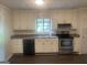Efficient kitchen with stainless steel appliances, white cabinets, and plenty of counter space at 212 Rockmart Rd, Villa Rica, GA 30180