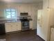 This kitchen features white cabinets, stainless steel appliances, and a window over the sink at 212 Rockmart Rd, Villa Rica, GA 30180