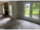 Open living room with stone fireplace and large windows at 212 Rockmart Rd, Villa Rica, GA 30180