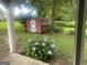 Backyard shed surrounded by lush greenery and hydrangeas providing extra storage at 212 Rockmart Rd, Villa Rica, GA 30180