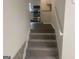Carpeted stairs leading up to the kitchen, providing a smooth transition between levels at 212 Rockmart Rd, Villa Rica, GA 30180