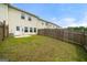 Fenced backyard featuring a small patio space and a green lawn at 8717 Lakeview Commons, Jonesboro, GA 30238