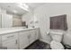 Bright bathroom featuring a white vanity with ample storage and large mirror at 8717 Lakeview Commons, Jonesboro, GA 30238