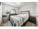 Well-lit bedroom showcasing a queen bed, dresser, and coordinated nightstands at 8717 Lakeview Commons, Jonesboro, GA 30238