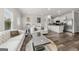 Open-concept living space featuring modern furnishings and a seamless flow into the kitchen at 8717 Lakeview Commons, Jonesboro, GA 30238