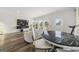 Open floor plan with living and dining area featuring hardwood floors and bright lighting at 8717 Lakeview Commons, Jonesboro, GA 30238