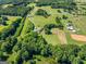 A captivating aerial perspective showcasing a property enveloped by verdant landscapes and mature trees at 226 Euharlee Five Forks Rd, Kingston, GA 30145