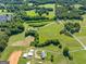 Picturesque aerial view of a home surrounded by lush fields and mature trees at 226 Euharlee Five Forks Rd, Kingston, GA 30145