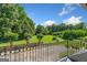 Lush backyard view from balcony featuring mature trees and manicured lawn at 226 Euharlee Five Forks Rd, Kingston, GA 30145
