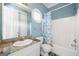 A compact bathroom offers a granite countertop vanity and a shower-tub combo with patterned curtain at 226 Euharlee Five Forks Rd, Kingston, GA 30145