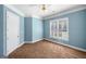 This bedroom is painted blue and features a ceiling fan and carpet floors at 226 Euharlee Five Forks Rd, Kingston, GA 30145