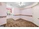 This bedroom with pink walls boasts carpet floors and window, and two entry doors at 226 Euharlee Five Forks Rd, Kingston, GA 30145