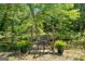 Charming bridge over a tranquil stream, adorned with potted flowers, creating a peaceful and inviting outdoor space at 226 Euharlee Five Forks Rd, Kingston, GA 30145