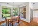 Sunny dining area with large windows, hardwood floors, and a view of the backyard at 226 Euharlee Five Forks Rd, Kingston, GA 30145