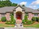 Elegant brick home featuring a grand entrance with stately columns, lush landscaping, and a well-manicured lawn at 226 Euharlee Five Forks Rd, Kingston, GA 30145
