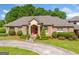 Brick home with lush landscaping, a circular driveway, and a grand entrance with stately columns at 226 Euharlee Five Forks Rd, Kingston, GA 30145
