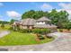 Beautiful two-story brick home with a well-manicured lawn, circular driveway, and three car garage at 226 Euharlee Five Forks Rd, Kingston, GA 30145