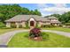 Beautiful brick home with manicured lawns, a circular driveway, and lush landscaping surrounding the property at 226 Euharlee Five Forks Rd, Kingston, GA 30145