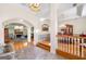 Grand foyer with marble floors, chandelier, and arched doorway leading to the living room and dining area at 226 Euharlee Five Forks Rd, Kingston, GA 30145