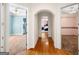 Hallway with hardwood floors leading to bedrooms and bathrooms with carpet and ceiling fans at 226 Euharlee Five Forks Rd, Kingston, GA 30145
