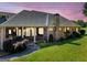 Charming brick home with a welcoming porch, landscaped garden, and beautiful evening sky, creating a warm ambiance at 226 Euharlee Five Forks Rd, Kingston, GA 30145