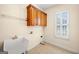 Functional laundry room with built-in storage and large utility sink next to bright window at 226 Euharlee Five Forks Rd, Kingston, GA 30145